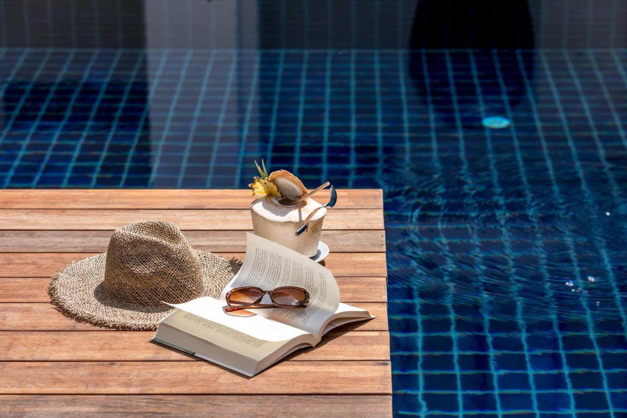 Outrigger Surin Beach Resort - Sha Extra Plus Exterior photo A poolside table
