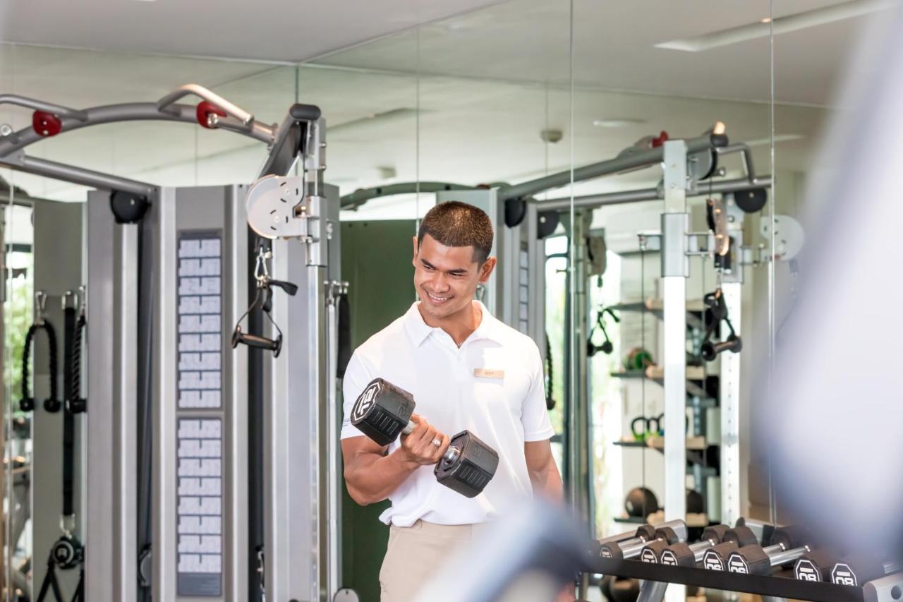 Outrigger Surin Beach Resort - Sha Extra Plus Exterior photo A man lifting a dumbbell