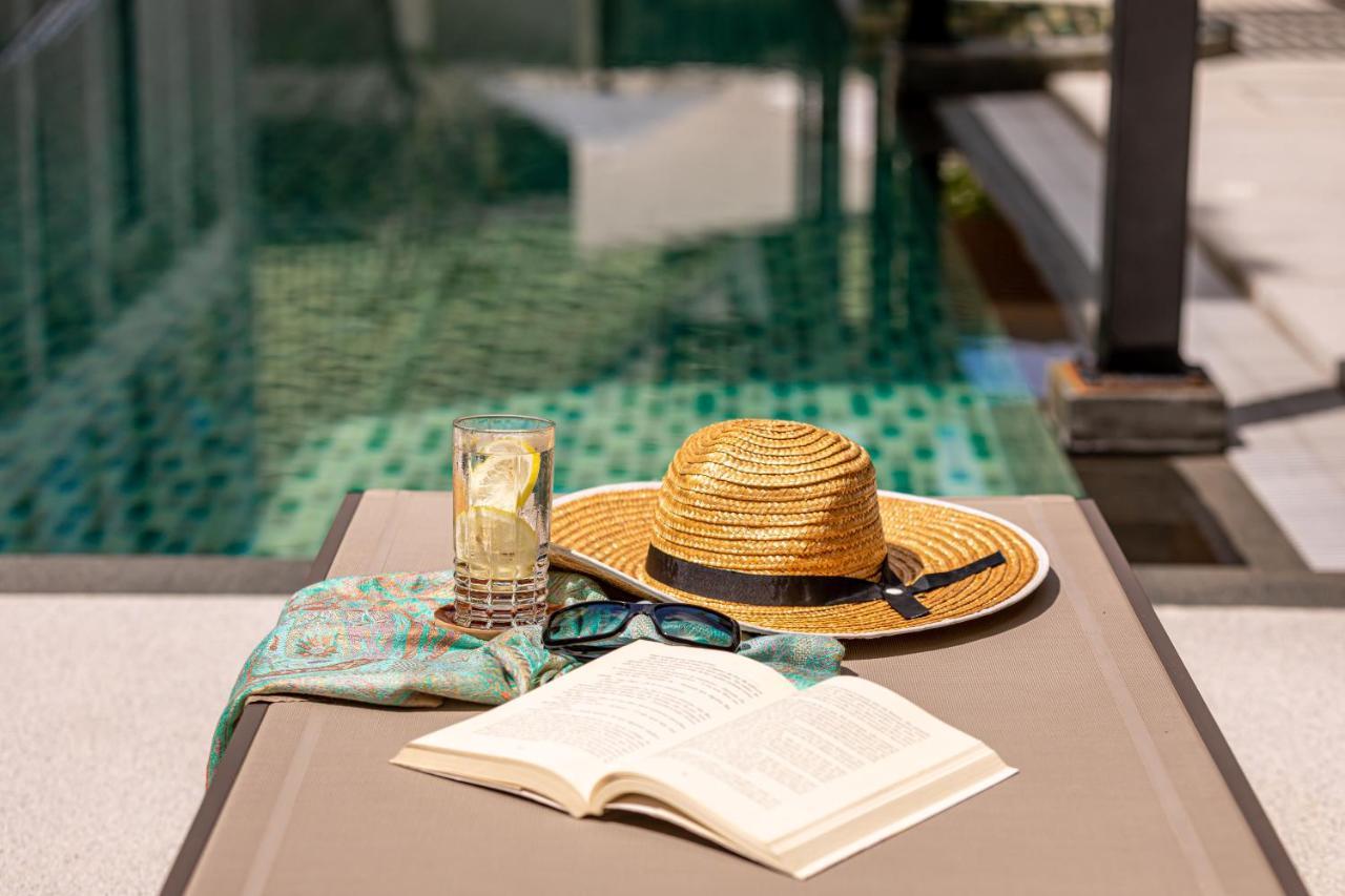 Outrigger Surin Beach Resort - Sha Extra Plus Exterior photo A poolside table